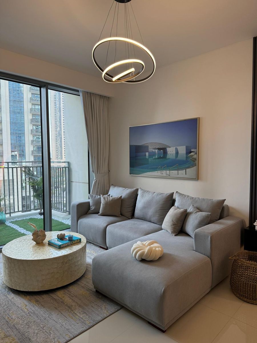 Grey chaise sofa with soft cushions beside the balcony