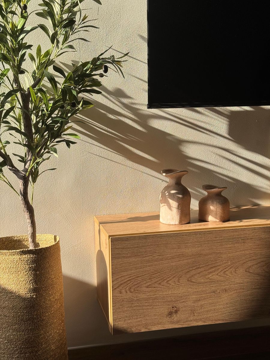 Clay vases on the oak console in late sun