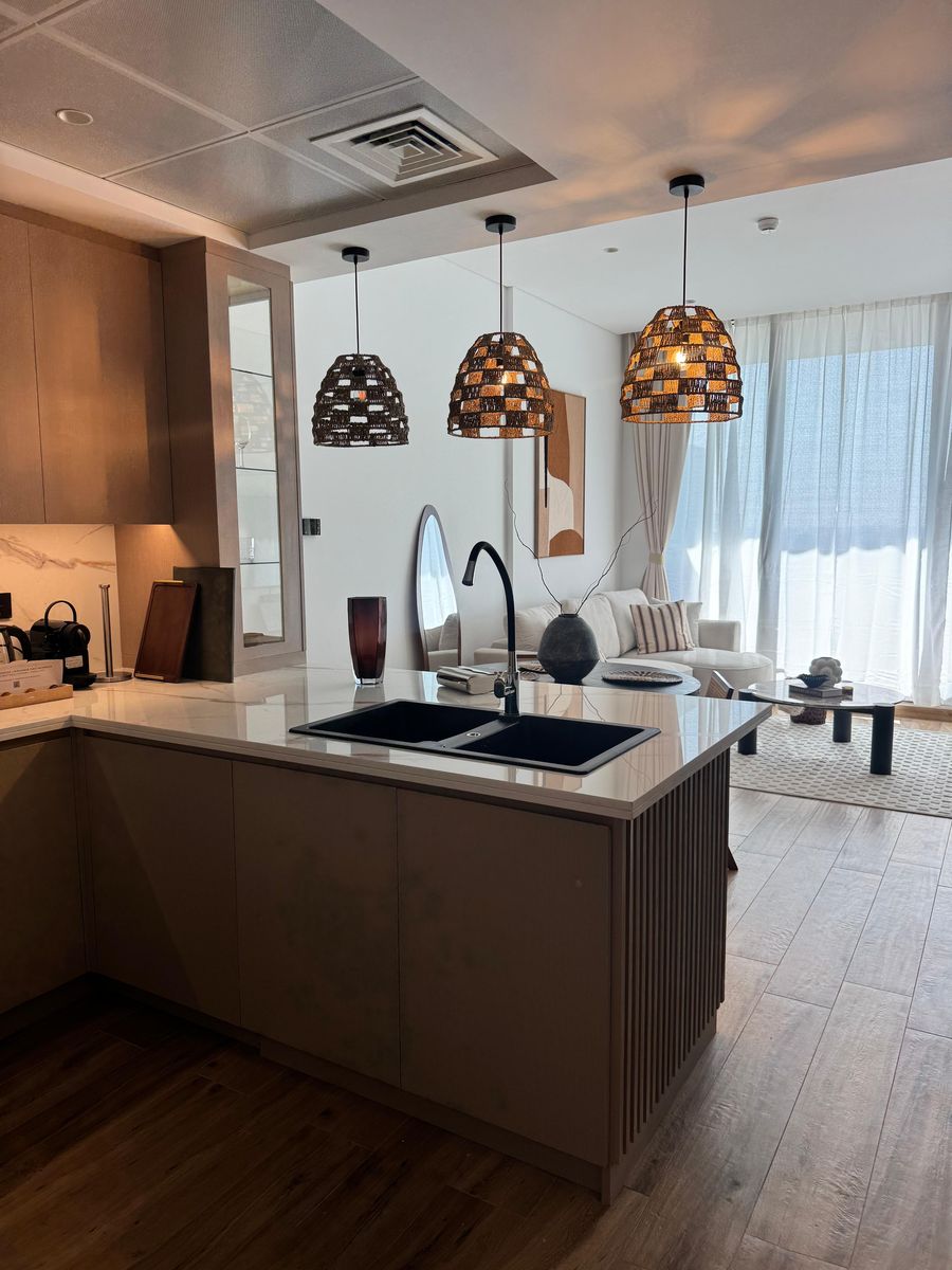 Kitchen island with woven pendants, looking into the living area