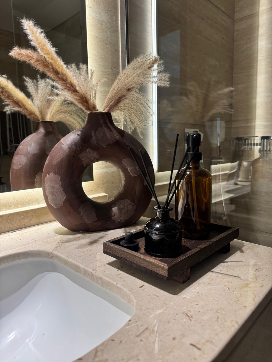 Ring vase with pampas grass on the stone vanity