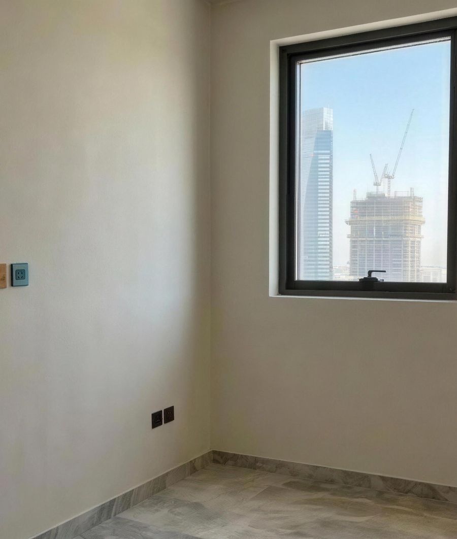 The children's room at handover: empty, with a window onto the towers