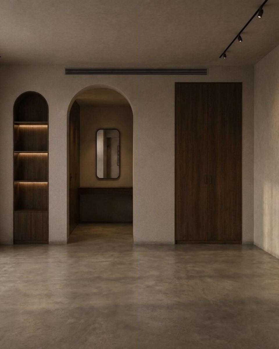The master bedroom after works: arches, a lit niche and limewash walls, before furniture