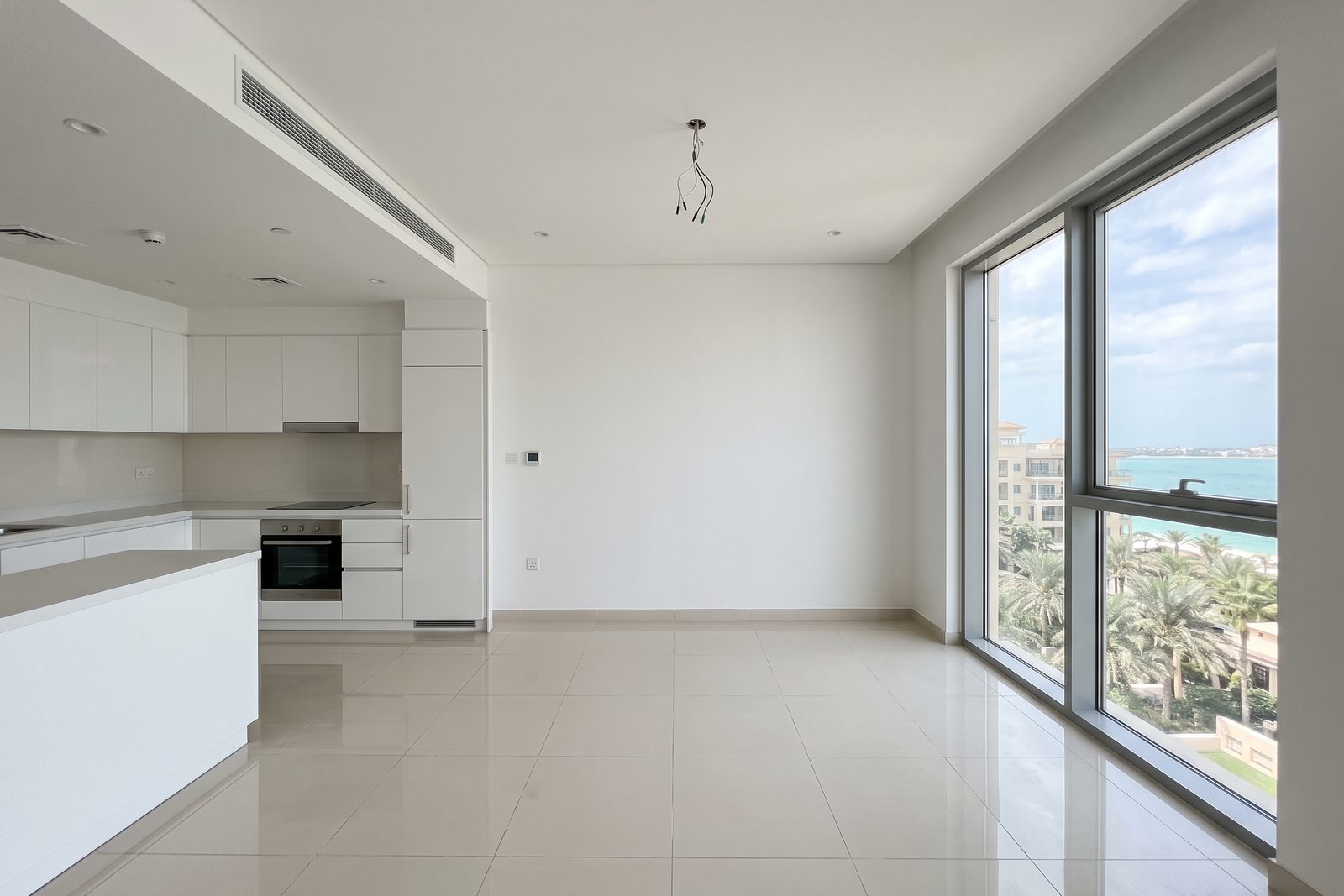 Visualisation: the dining area and open kitchen of a typical Palm Jumeirah apartment at handover, empty