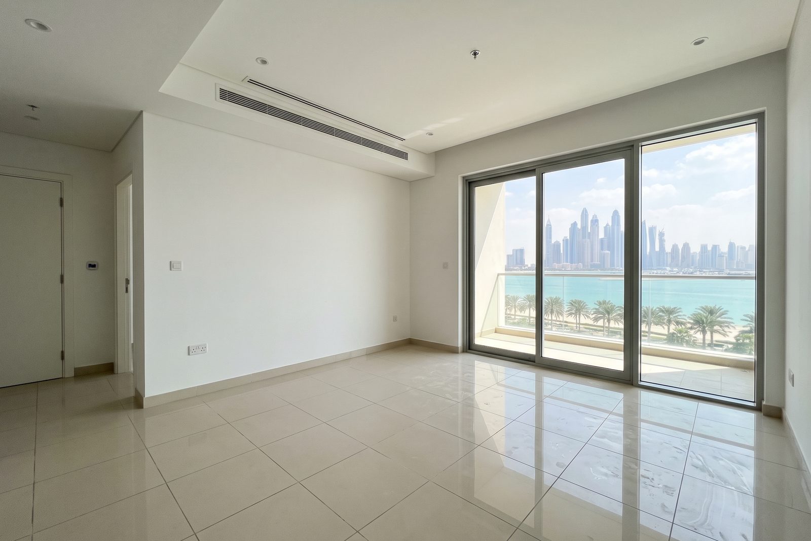 Visualisation: the living room of a typical Palm Jumeirah apartment at handover, empty, with sliding doors to the balcony and a skyline view