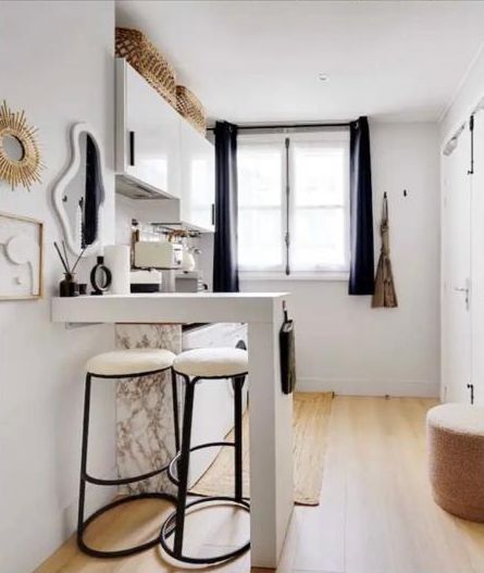 The kitchen after: a bar counter with bouclé stools, curtains and styled shelves